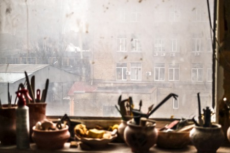 windowsill on which stand in vases tools in potteryの写真素材