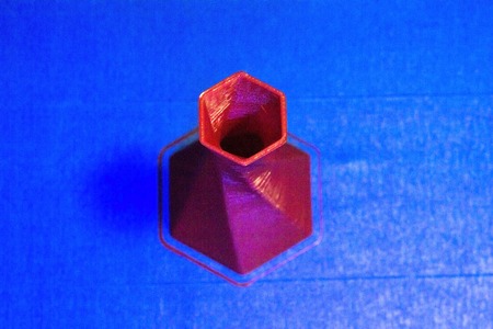 3D printer printing object red color on the basis of blue top viewの写真素材