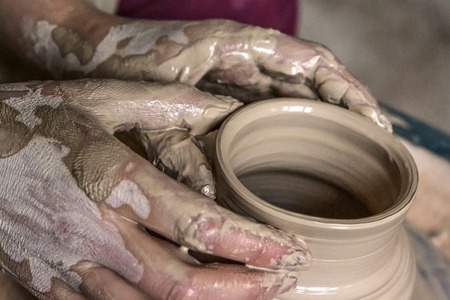 Potter makes a jug out of clay. Top view