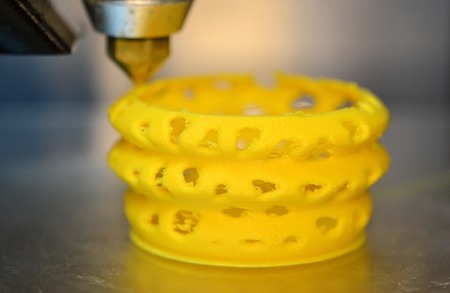 3d printer printing objects yellow form closeup. Modern technical 3D printing.の写真素材