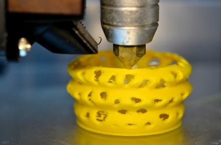 3d printer printing objects yellow form closeup. Modern technical 3D printing.の写真素材