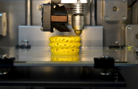 3d printer printing objects yellow form closeup. Modern technical 3D printing.の写真素材