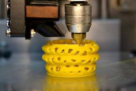 3d printer printing objects yellow form closeup. Modern technical 3D printing.の写真素材