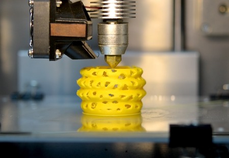 3d printer printing objects yellow form closeup. Modern technical 3D printing.の写真素材
