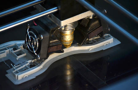3D printer print isolated objects on mirror reflective surface close-up. Modern 3D printing technology. Top viewの写真素材