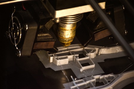 3D printer print isolated objects on mirror reflective surface close-up. Modern 3D printing technology. Top viewの写真素材