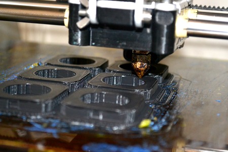 Modern 3D printer printing figure close-up macro. Automatic three dimensional 3d printer performs plastic modeling in laboratory.の写真素材