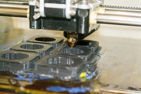 Modern 3D printer printing figure close-up macro. Automatic three dimensional 3d printer performs...