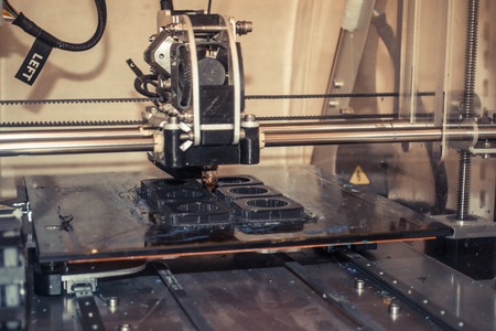 Modern 3D printer printing figure close-up macro. Automatic three dimensional 3d printer performs...