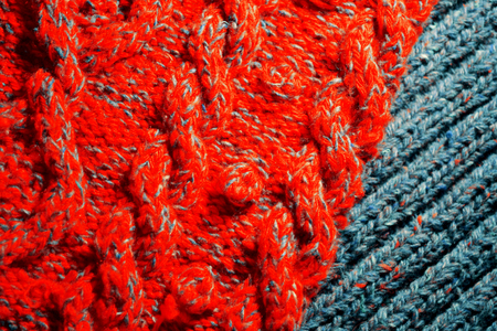 Background of knitting red and blue patterns, knitting wool texture background close-up, macroの写真素材