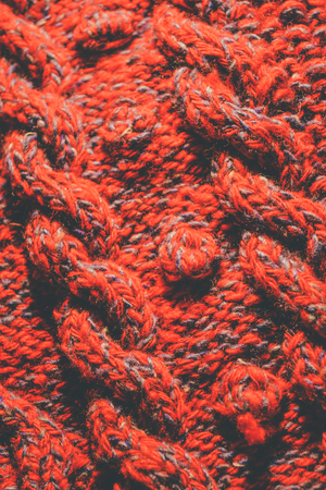 Background of knitting red and blue patterns, knitting wool texture background close-up, macroの写真素材