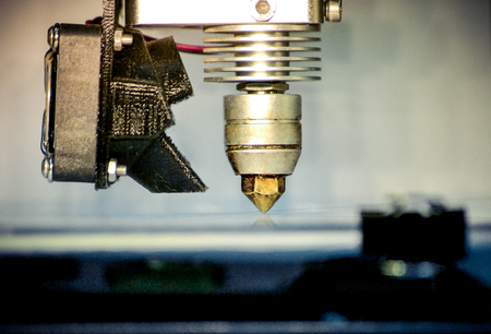 Modern 3D printer printing figure close-up macro. Automatic three dimensional 3d printer performs plastic modeling in laboratory. 3d-printing processing with white backgroundの写真素材