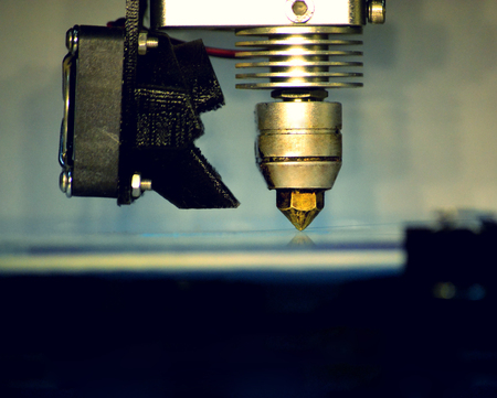Modern 3D printer printing figure close-up macro. Automatic three dimensional 3d printer performs plastic modeling in laboratory. 3d-printing processing with white backgroundの写真素材