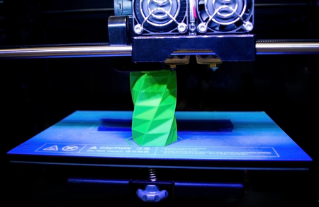 3D printer works and creates an object from the hot molten plastic close-up. Automatic three...