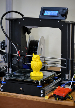 Modern 3D printer printing figure close-up. Automatic three dimensional 3d printer performs plastic...