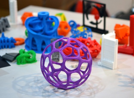 shape printed by 3d printer. Bright colorful objects printed on a 3d printer on a tableの写真素材