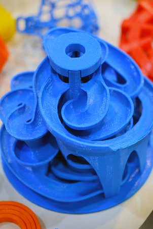 Objects printed by 3d printer. Bright colorful objects printed on a 3d printer on a tableの写真素材