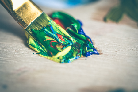 Brush in oil paint of different colors. Place for text. Creative backgroundの写真素材