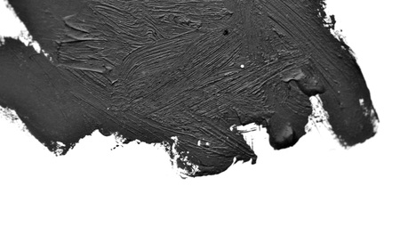 black brush strokes oil paints on white paper. Isolated on white background. Abstract creative backgroundの写真素材