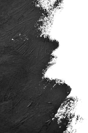 black brush strokes oil paints on white paper. Isolated on white background. Abstract creative backgroundの写真素材
