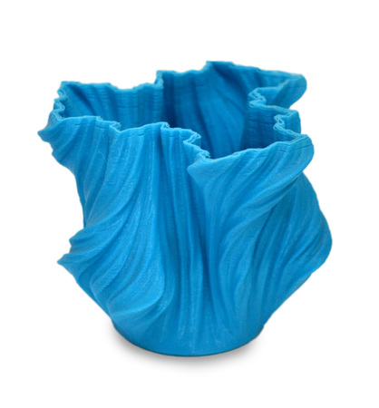 Objects printed by 3d printer Isolated on white background. Bright colorful object. Vase of blue color. Automatic three dimensional performs plastic modeling. Modern 3D printing technology.の写真素材