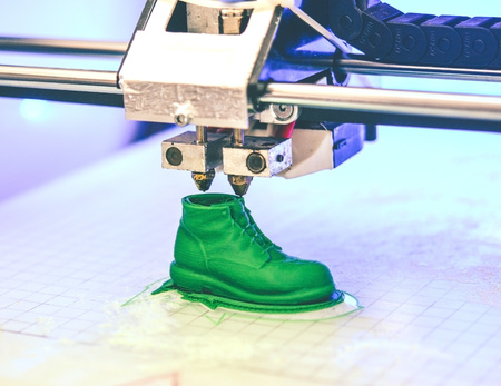 3D printer prints the form of molten plastic green close-up. Automatic three dimensional 3d printer performs plastic modeling in laboratory. Progressive modern additive technologyの写真素材