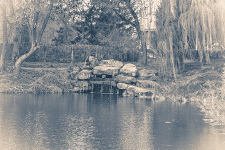 Vintage photo park with a lake or a pond and treesの写真素材