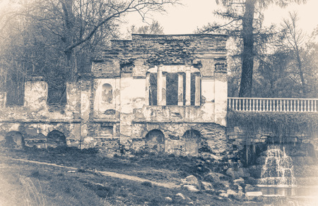 Vintage photo park with ancient ruins and a treeの写真素材