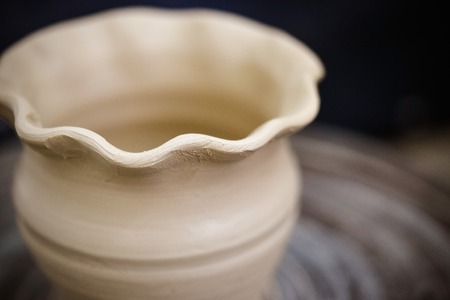 Raw clay vase, upper edge of the vase wave close-upの写真素材