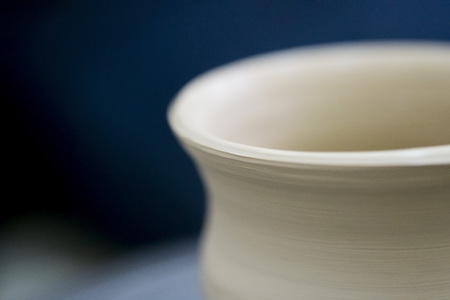 Raw clay vase spinning potters wheel macroの写真素材