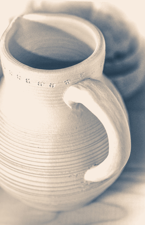 Old vintage photo. Jug of clay. Pitcher made of white clay. Before firing. Top viewの写真素材