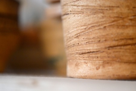 Side of pottery from clay with painted lines macroの写真素材