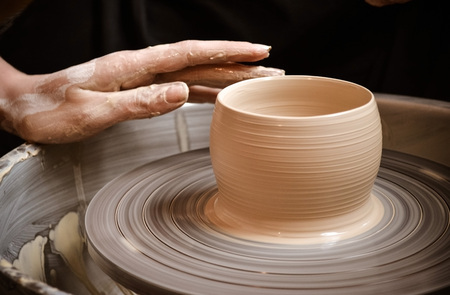 Master class on modeling of clay on a potter's wheel In the pottery workshopの写真素材