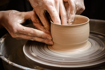 Master class on modeling of clay on a potter's wheel In the pottery workshopの写真素材