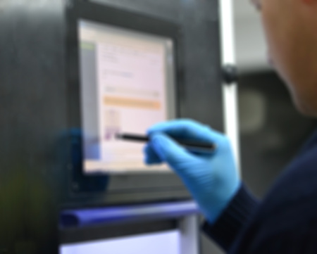 The man works on the machine sensory monitor. Blurred backgroundの写真素材