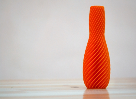 The model printed on a 3d printer. Vase of orange color. Progressive modern additive technology.Copy spase, spase for text.の写真素材