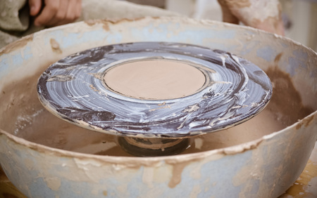 An empty circle, where the potter molds product close-up. Creative studio potter. Workplace wizard Crock potteryの写真素材