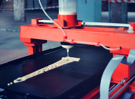 3d printer that printing a liquid dough. 3D printer printing pancakes with liquid dough different shapes close-up. Modern additive technologies 4.0 industrial revolutionの写真素材