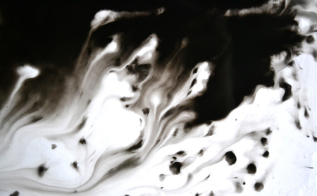 Black Ink Conveyed Over White Close-up Paper. Abstract Background isolated on white background. Ink...