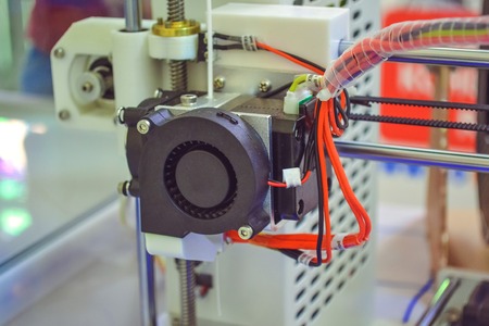 Objects printed by 3d printer. Automatic three dimensional 3d printer performs plastic modeling in laboratory. Progressive modern additive technologyの写真素材