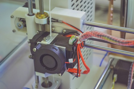 Objects printed by 3d printer. Automatic three dimensional 3d printer performs plastic modeling in laboratory. Progressive modern additive technologyの写真素材