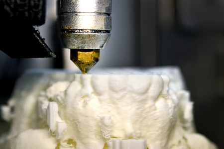 3D printer prints the form of molten plastic white close-up. Automatic three dimensional 3d printer performs plastic modeling in laboratory. Progressive modern additive technologyの写真素材