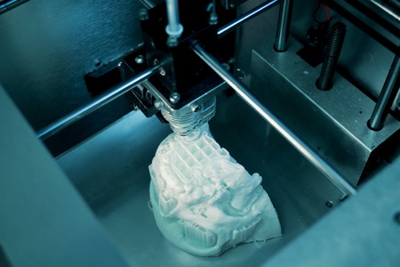 3D printer prints the form of molten plastic white close-up. Automatic three dimensional 3d printer...