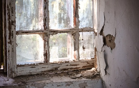 Old window with shabby cracked paint In the old forgotten houseの写真素材