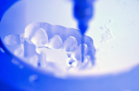 Dental milling machine carving out shape of human teeth close-up. Modern medical technologies. Concept of 4.0 industrial revolutionの写真素材