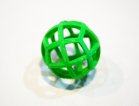 Abstract object of a green color printed by 3d printer on white background. Fused deposition...