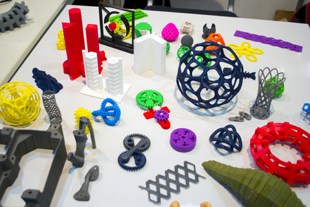 Abstract models printed by 3d printer close-up. Bright colorful objects printed on a 3d printer on a white table. Progressive modern additive technology. Concept of 4.0 industrial revolutionの写真素材