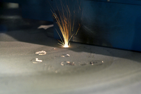 3D printer printing metal. Laser sintering machine for metal. Metal is sintered under the action of...
