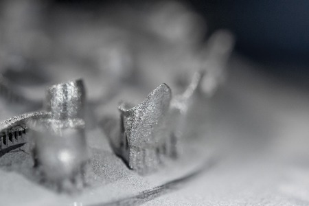 Printing platform with object printed on 3d printer for metal and covered metallic powder. 3D printer printing metal. Laser sintering machine for metal. Progressive DMLS, SLM, SLS additive technologyの写真素材