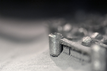Printing platform with object printed on 3d printer for metal and covered metallic powder. 3D printer printing metal. Laser sintering machine for metal. Progressive DMLS, SLM, SLS additive technologyの写真素材